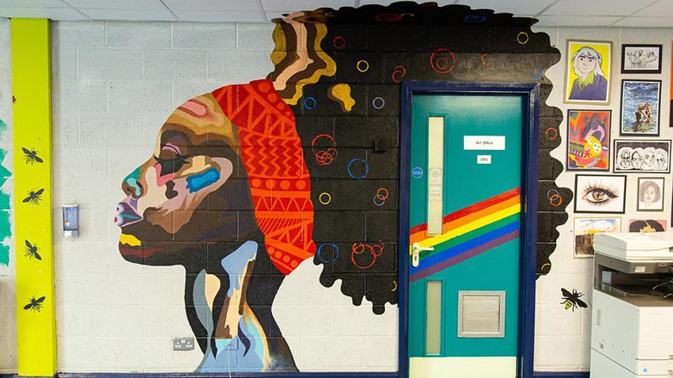 A bright mural on a school corridor